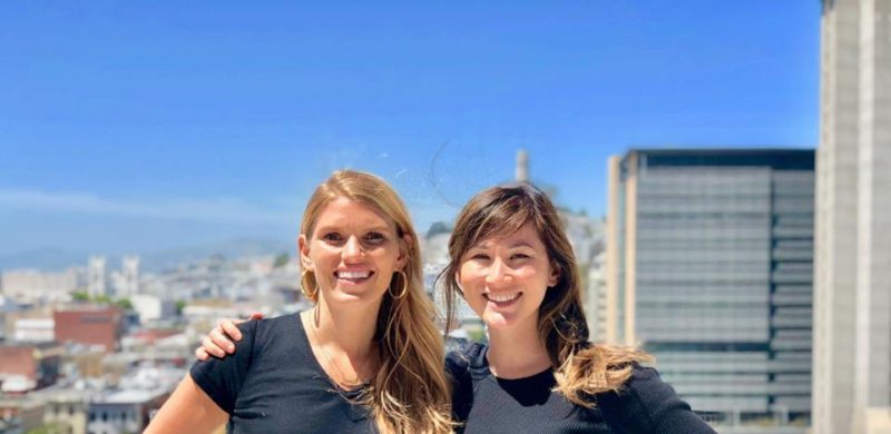 Two friends standing in front of a skyline