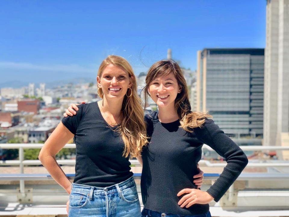 Two friends standing in front of a skyline