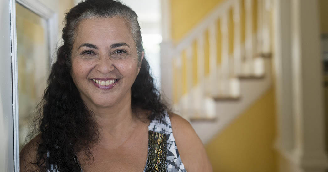 Woman smiling in sunny staircase