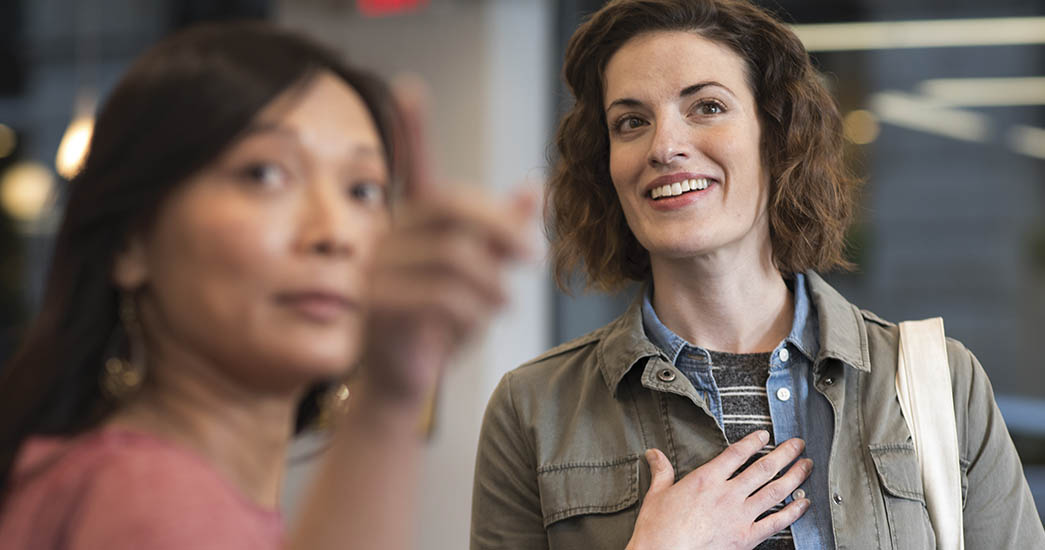 Employer showing employee new technology in the distance by pointing