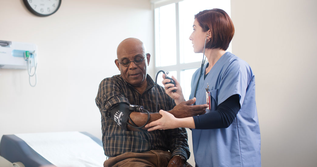 Doctor checking patients blood pressure