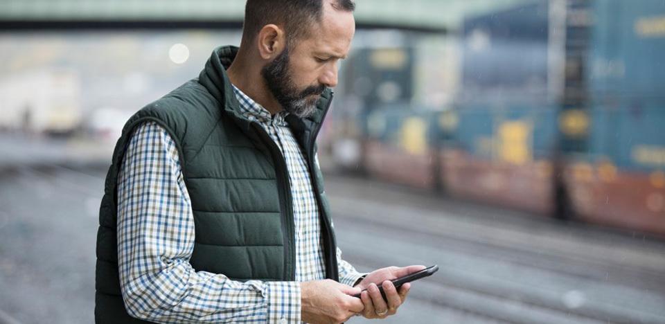 Man on his cell phone at a train station