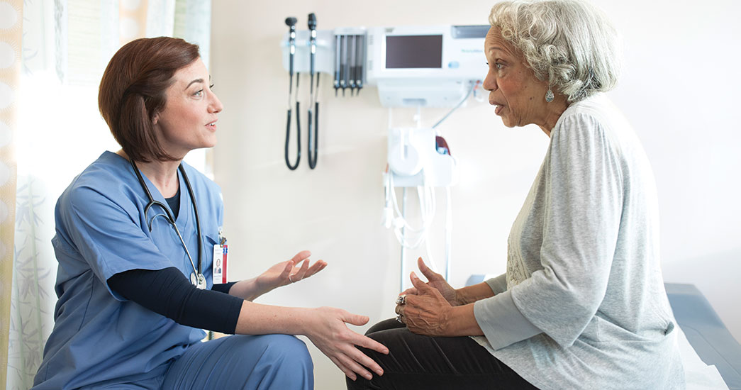 Doctor answering questions about health care to a patient