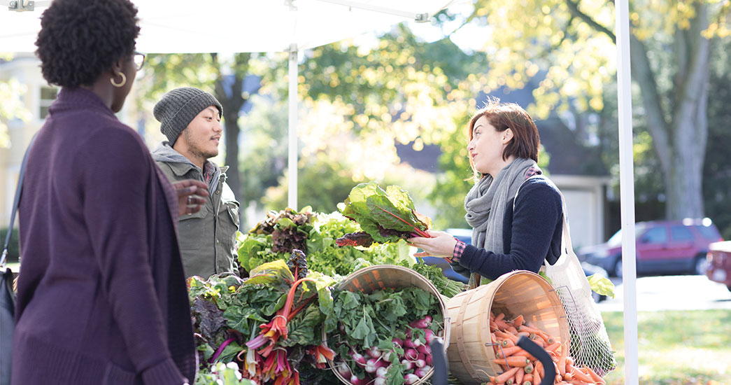 Woman buying lettuce at a farmer's market