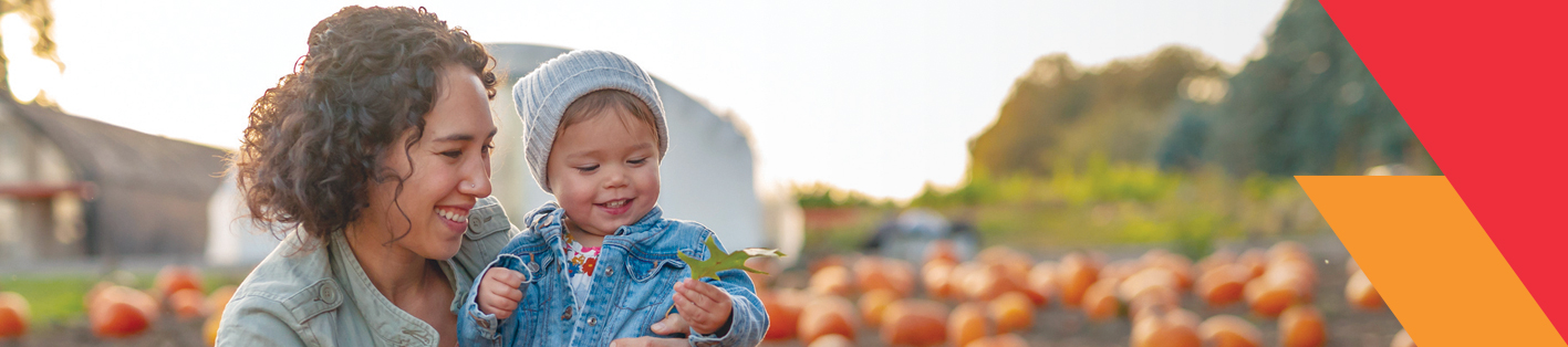 Mother with her baby at a pumpkin patch